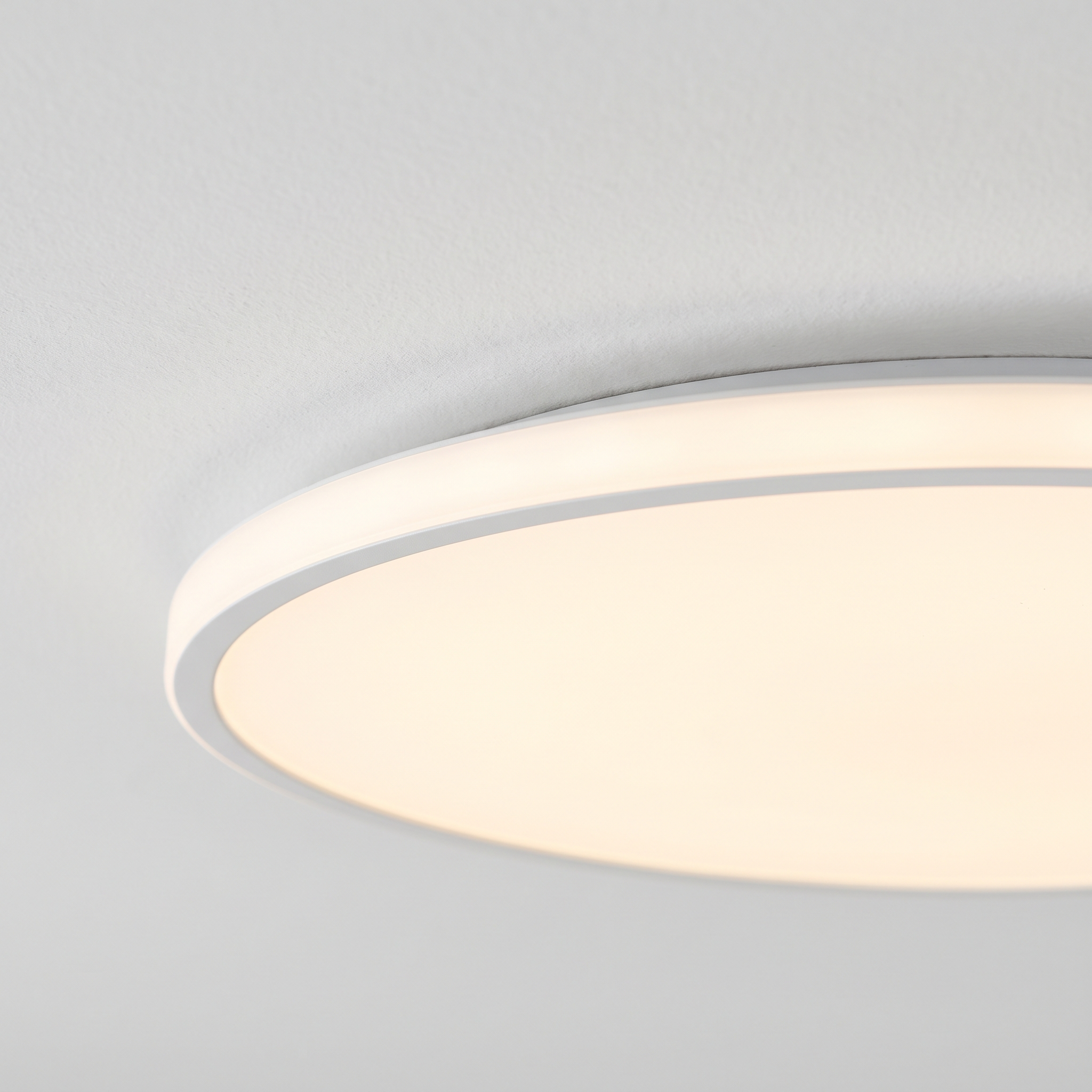 Close detail of the slim rim where the panel meets the ceiling