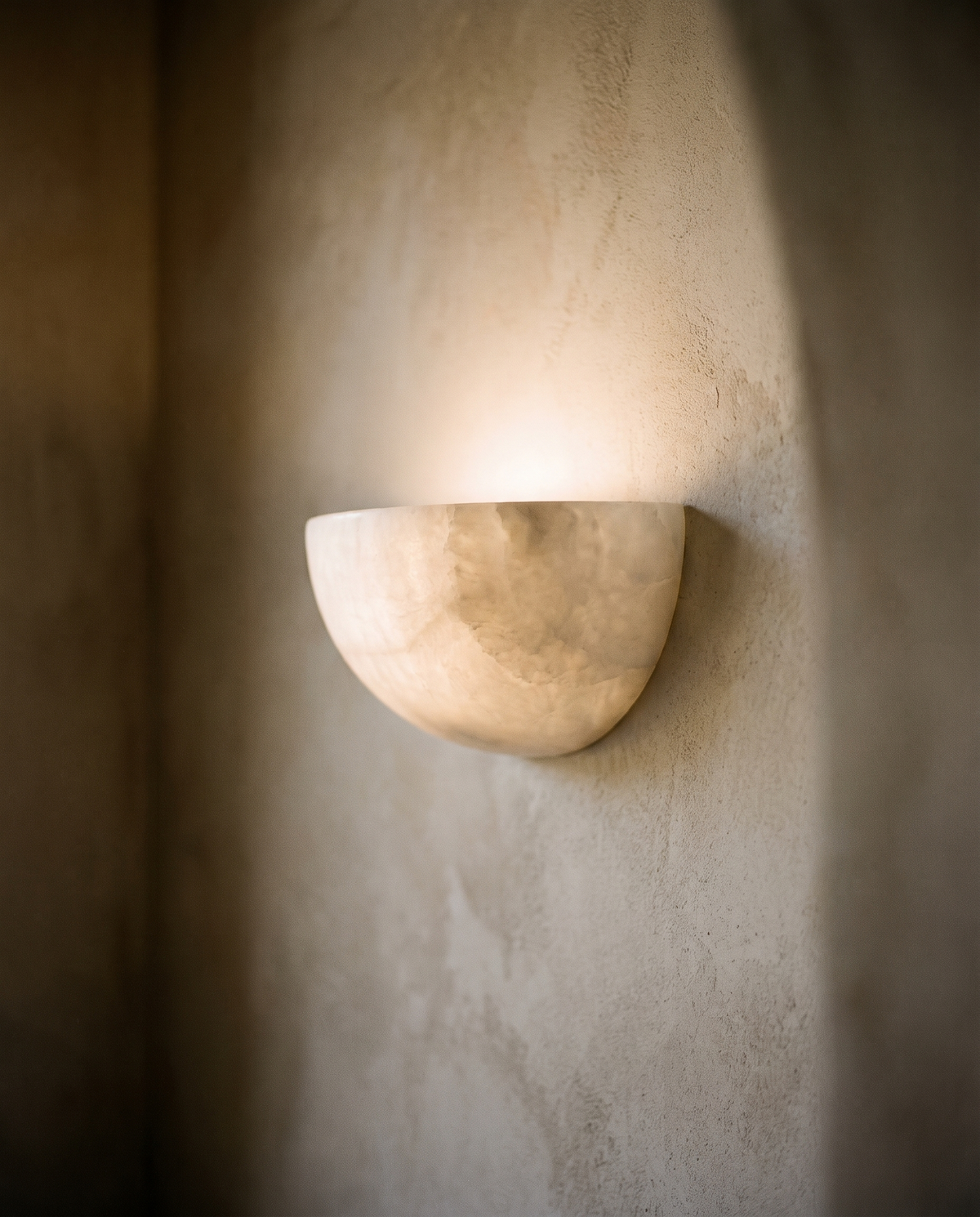 Wall sconce mounted on a plaster wall